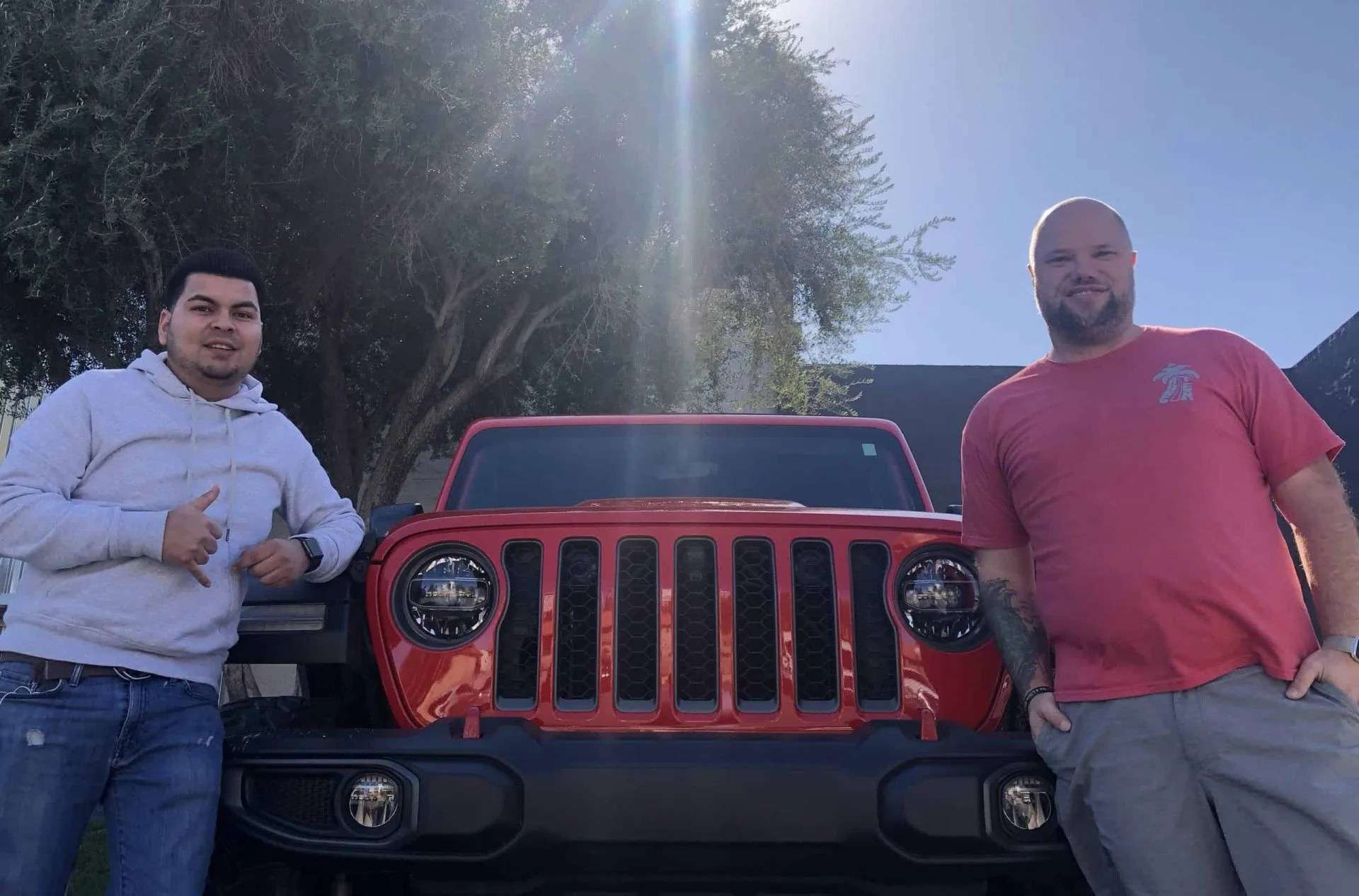 The Vegas Jeep Tours team with a custom red Jeep Wrangler