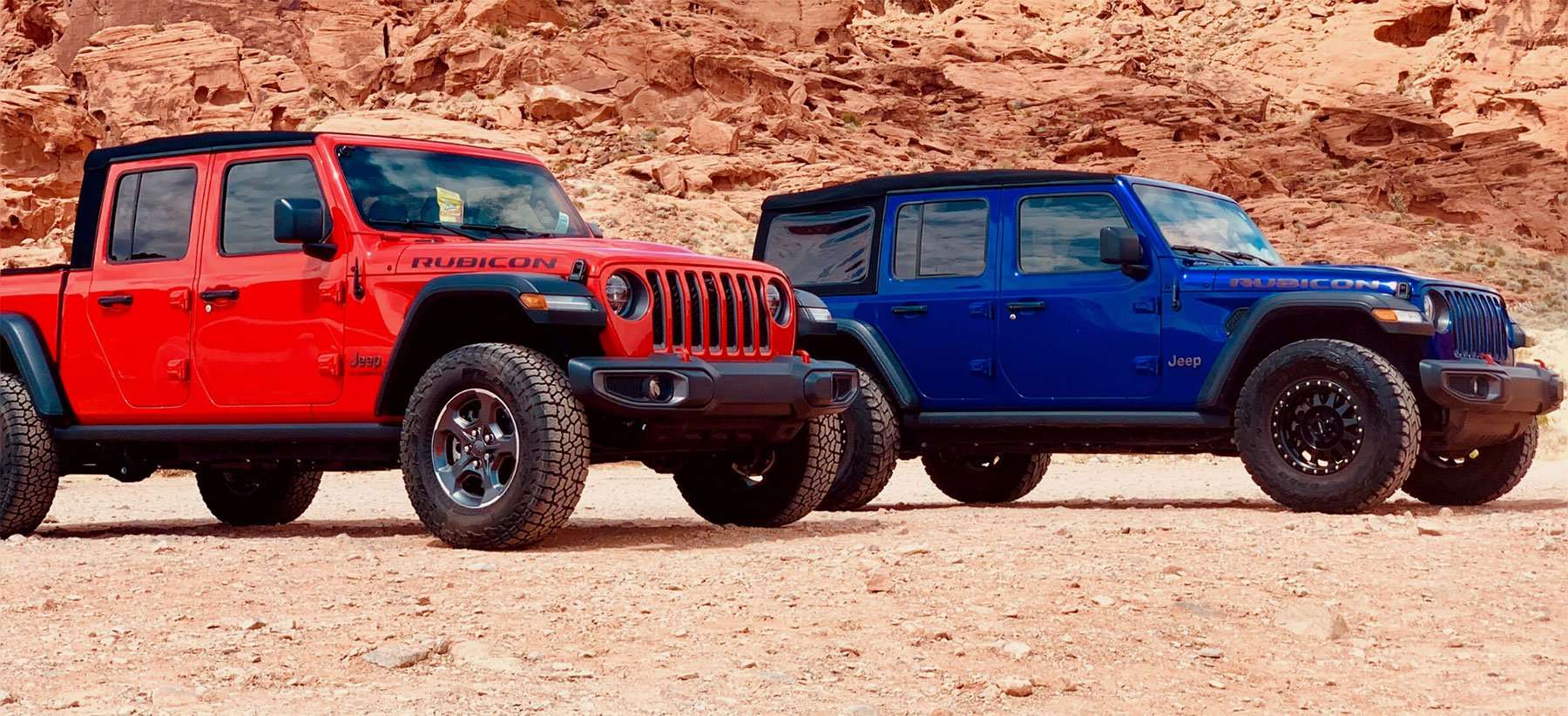 Red and blue Jeep Gladiators from the Vegas Jeep Tours fleet