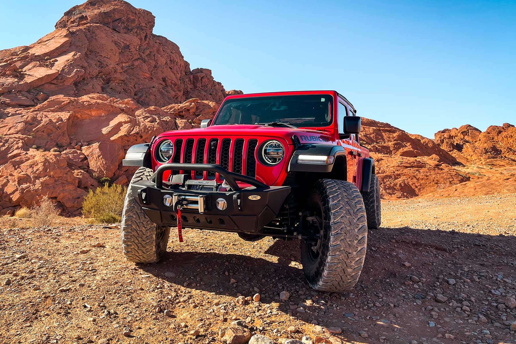 Red Jeep Gladiator among the red rocks outside Las Vegas